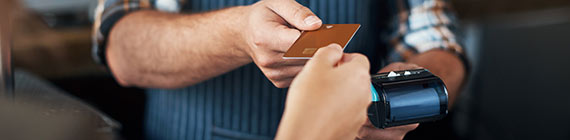 Woman handing card to male worker.