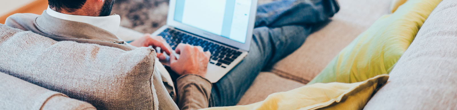 Man on laptop on couch