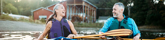 Mature couple on canoes.