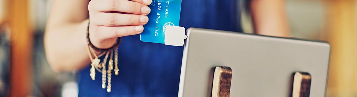 Man swiping card on tablet reader